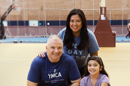 A family on a basketball court at the YMCA.