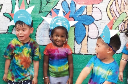 Kids wearing tie dye tee shirts at the Flushing YMCA summer camp.