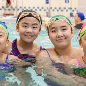 Four girls swimming in Coney Island YMCA pool in Brooklyn